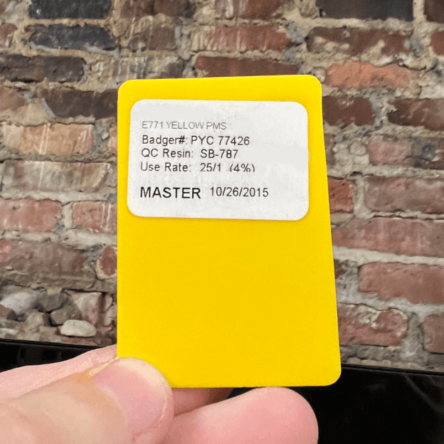 A hand holding a yellow cardAI-generated content may be incorrect.